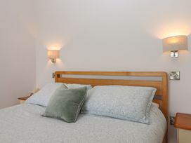 A bedroom with a bed and bedside table at The Pennymoor Cadeleigh near Tiverton
