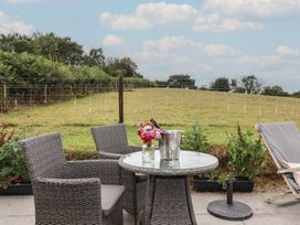 A seating area with a table and chairs at The Pennymoor in Cadeleigh near Tiverton
