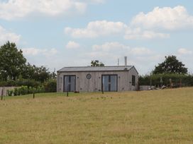 A building with doors and windows on a grassy field at The Pennymoor in Cadeleigh near Tiverton