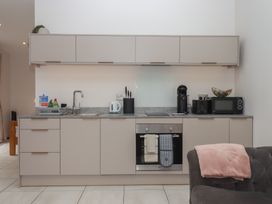 A kitchen with cabinets, sink, oven, microwave and coffee machine at The Bickleigh in Cadeleigh near Tiverton