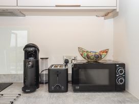 A kitchen with coffee machine toaster microwave and fruit bowl at The Bickleigh Cadeleigh near Tiverton