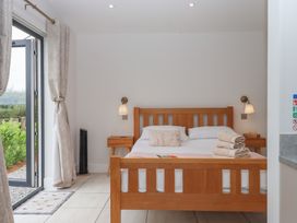 A bedroom with a bed and bedside table at The Bickleigh in Cadeleigh near Tiverton