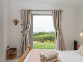 A bedroom with a bed and view of outdoor landscape at The Bickleigh in Cadeleigh near Tiverton