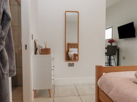A bedroom with a bed and a mirror at The Bickleigh in Cadeleigh near Tiverton