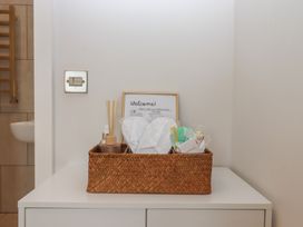 A bathroom counter with a basket of toiletries at The Bickleigh in Cadeleigh near Tiverton