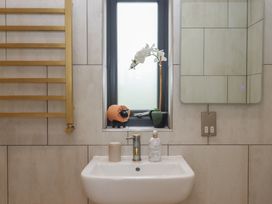 A bathroom with a sink and mirror at The Bickleigh near Tiverton