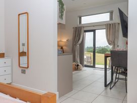 A living room with a mirror and a view of the outdoors at The Bickleigh Cadeleigh near Tiverton