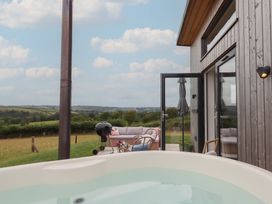 An outdoor area with a hot tub and seating at The Bickleigh in Cadeleigh near Tiverton