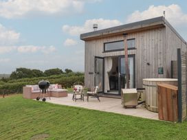 An outdoor area with seating and barbecue at The Bickleigh in Cadeleigh near Tiverton