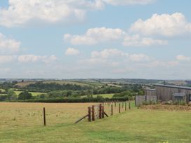 A field with a fence and building at The Bickleigh in Cadeleigh near Tiverton