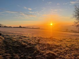 A field with the sun rising above at The Bickleigh in Cadeleigh near Tiverton