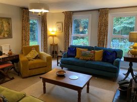 A living room with sofa and armchair at Greywalls in Maulds Meaburn