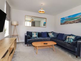 A living room with a sofa and coffee table at Chi Gwynn in Crantock