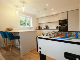 A kitchen with a foosball table and bar stools at Chi Gwynn in Crantock