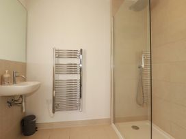 A bathroom with a shower and wash basin at Chi Gwynn in Crantock