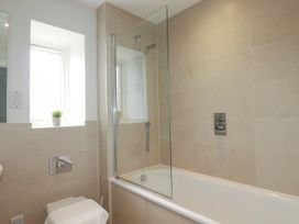 A bathroom with a bathtub and a shower at Chi Gwynn in Crantock