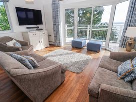 A living room with a television and sofas at Tremorna Vista in Carbis Bay