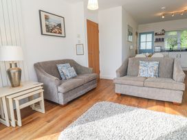 A living room with two sofas and a lamp at Tremorna Vista in Carbis Bay