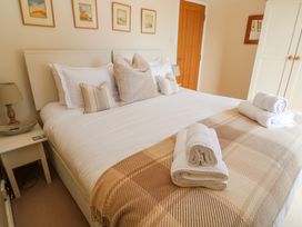 A bedroom with a bed and bedside table at Tremorna Vista, Carbis Bay