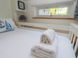 A bedroom with a bed and towels at Tremorna Vista in Carbis Bay