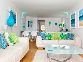 A living room with a sofa and table at Ultramarine in Carbis Bay