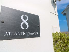 A nameplate displaying number 8 and text Atlantic Waves at Atlantic Waves in Carbis Bay