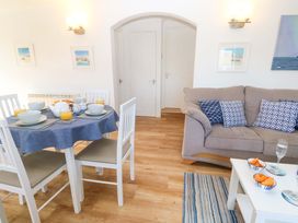 A dining room with a table and chairs at Atlantic Waves in Carbis Bay