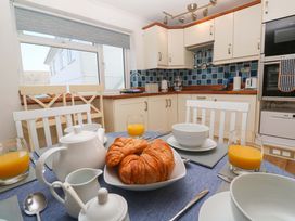 A dining room with a table set for breakfast at Atlantic Waves in Carbis Bay