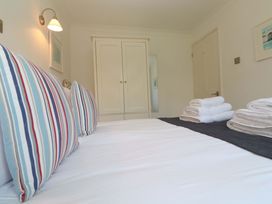 A bedroom with a bed and towels at Atlantic Waves in Carbis Bay