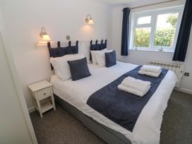 A bedroom with a bed and bedside table at Atlantic Waves in Carbis Bay