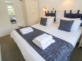 A bedroom with a bed and towels on it at Atlantic Waves in Carbis Bay