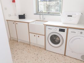 A laundry room with a washing machine and sink at Bayside in Carbis Bay