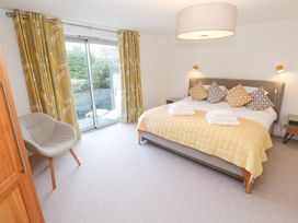 A bedroom with a bed and chair at Bayside in Carbis Bay