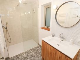 A bathroom with shower and sink at Bayside Carbis Bay