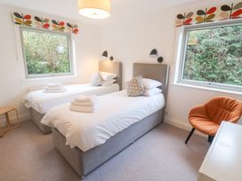 A bedroom with two beds and a chair at Bayside in Carbis Bay