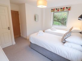 A bedroom with twin beds and a window at Bayside in Carbis Bay