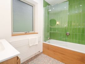 A bathroom with a bathtub and sink at Bayside in Carbis Bay