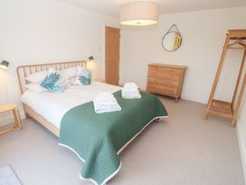 A bedroom with a bed and dresser at Bayside in Carbis Bay