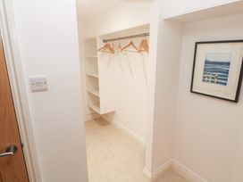 A closet with shelves and hangers at Bayside in Carbis Bay