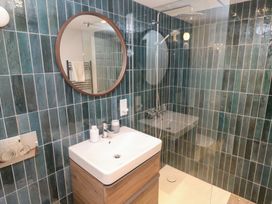 A bathroom featuring a sink, shower, and mirror at Bayside, Carbis Bay