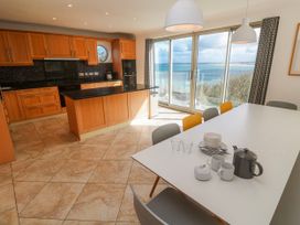 A kitchen with a dining table and ocean view at Bayside in Carbis Bay