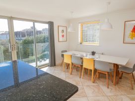 A dining room with a table and chairs at Bayside in Carbis Bay