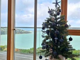 A christmas tree with decorations and ocean view at Sea Mist in Carbis Bay
