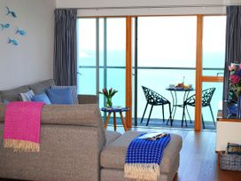 A living room with a sofa and balcony view at Sea Mist in Carbis Bay