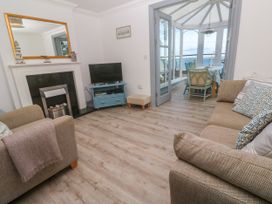 A living room with a television and fireplace at Ocean Gem in Carbis Bay