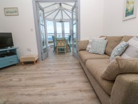 A living room with a sofa and television at Ocean Gem in Carbis Bay