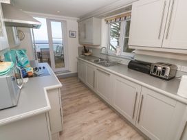 A kitchen with a microwave and sink at Ocean Gem in Carbis Bay