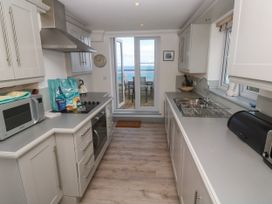 A kitchen with appliances and a view at Ocean Gem in Carbis Bay
