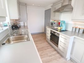 A kitchen with a sink and appliances at Ocean Gem in Carbis Bay