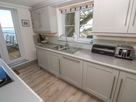 A kitchen with a sink and cabinets at Ocean Gem in Carbis Bay